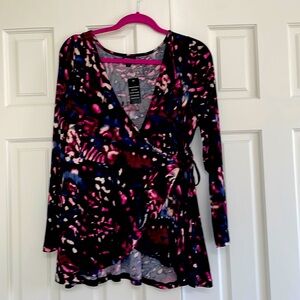 Torrid wrap top,  black background, with blue, burgundy and cream
